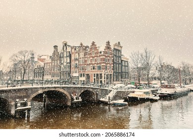 Winter snow view of Dutch canal and old houses in the historic city of Amsterdam - Powered by Shutterstock