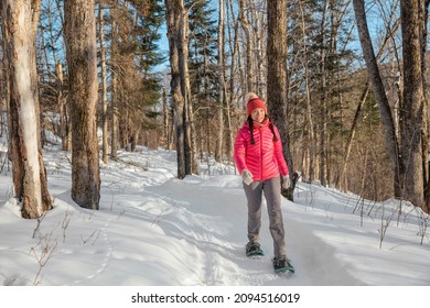 Winter Snowshoe Hiking People. Snowshoeing Asian Multiracial Woman In Winter Forest On Hike In Snow Wearing Snowshoes Living Healthy Active Outdoor Lifestyle.