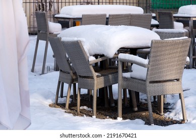 Winter Snowy Garden Furniture On A Terrace. Winter Rest In Restaurants And Cafes