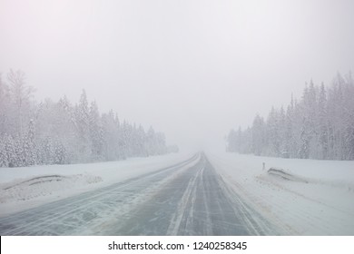 Winter Snowy Road In A Forest Without Cars. Dangerous Driving Conditions In Winter In Cloudy Weather.