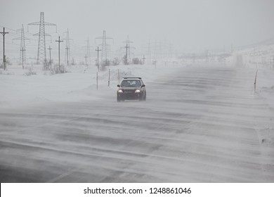 Winter, Snowy Road, Snowing And Strong Wind, One Car Rides In The Fog