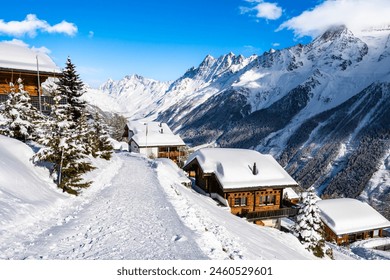 Winter snowy road with typical wooden houses in alpine village, Loetschental valley, Switzerland - Powered by Shutterstock