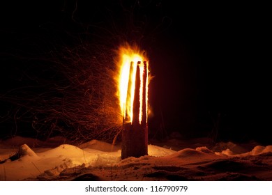 Winter Solstice Pagan Traditions In Latvia. Yule Log Burning Ritual. The Ritual Is Symbolic Of Joint Effort To Combat The Power Of Darkness And To Turn Toward The Light Once Again.