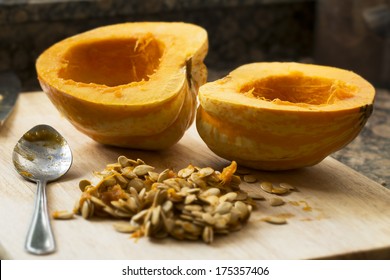 Winter Squash Cut In Half With Spoon And Seeds Scooped Out.