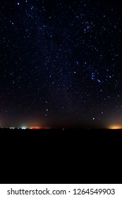 Winter Stars Night And Distant City Lights.