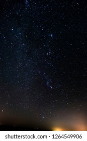 Winter Stars Night And Distant City Lights.