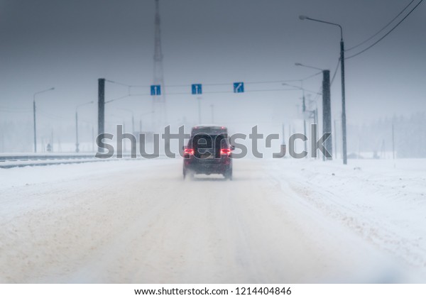 Winter Storm Traffic. Highway During Snow Storm.\
Heavy Snowfall and Heavy\
Traffic.