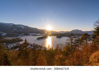 Winter sun setting at lake Faaker See with Karawanken mountains in the background, Villach, Carinthia, Austria