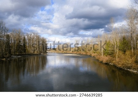 Winter sunlight through partly cloudy sky on the Snoqualmie River