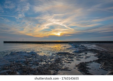 Winter Sunrise On An Icy Beach