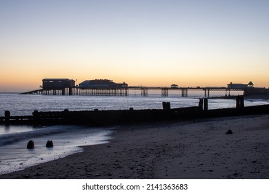 Winter Sunrise Over The Beach, Pier And Promenade At Cromer In North Norfolk, UK