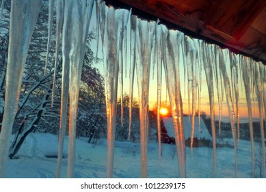 Winter sunrise scene with hanging icicles