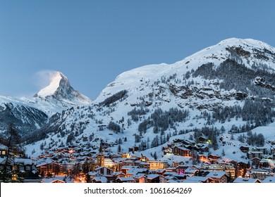 Winter Sunrise View On Snowy Matterhorn, Blue Sky And Zermatt Village, Switzerland.