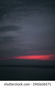 Winter Sunset Sky. Distant City Lights On The Horizon.