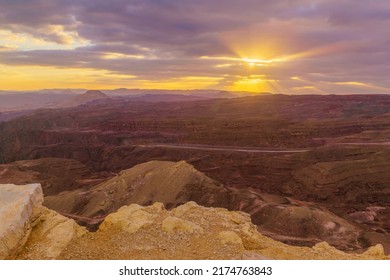 Winter sunset view from Mount Yoash with sunbeams and the Egyptian border. Massive Eilat Nature Reserve, southern Israel