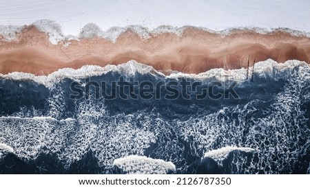 Winter swim in Baltic sea, Poland. Extreme sport in winter. Aerial view of winter