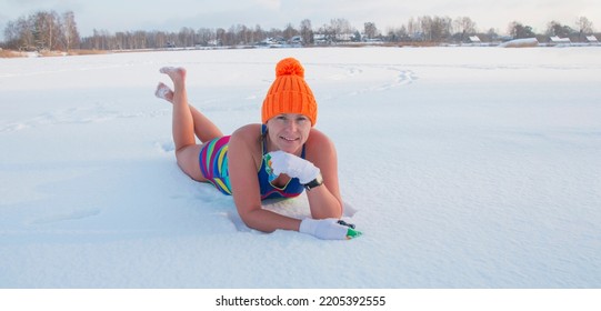 Winter Swimming. 50 Year Old Woman On The Snow Of A Frozen Lake. Recovery And Extreme Hardening On Ice Snow. Hardening And Youth.