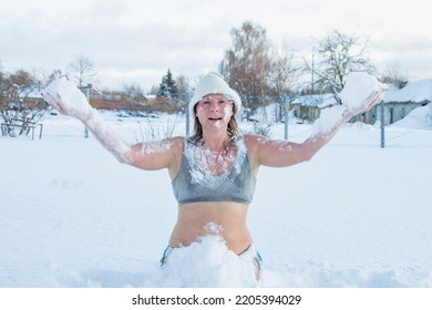 Winter Swimming. 50 Year Old Woman On The Snow Of A Frozen Lake. Recovery And Extreme Hardening On Ice Snow. Hardening And Youth.