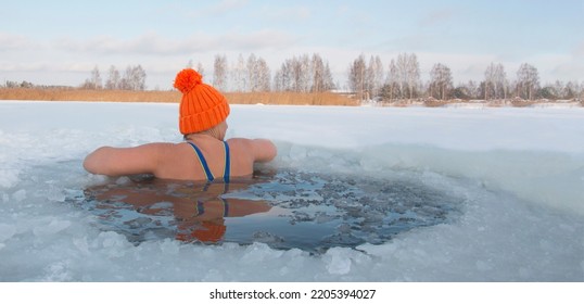 Winter Swimming. 50-year-old Woman In A Hole In A Frozen Lake. Recovery And Extreme Swimmers In Ice Water. Hardening Youth .Place For Text