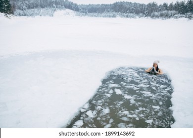 Winter Swimming. Woman In Frozen Lake Ice Hole. Swimmers Wellness In Icy Water. How To Swim In Cold Water. Beautiful Young Female In Zen Meditation. Swimming Clothes. Nature Lake. Place For Text