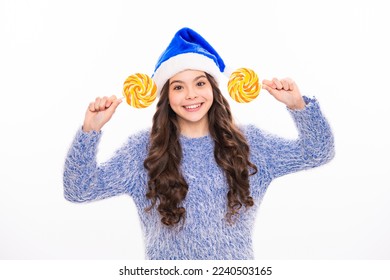 Winter teen girl hold christmas lollipop. Winter child isolated portrait. Teen girl on xmas holiday. Merry christmas and happy new year. Banner of christmas child girl in studio.