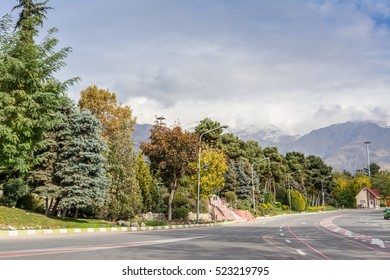 Winter Tehran Street View In Tehran International Exhibition Center With Snow Covered Alborz Mountains Against Cloudy Sky On Background