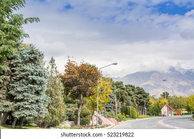 Winter Tehran Street View In Tehran International Exhibition Center With Snow Covered Alborz Mountains Against Cloudy Sky On Background