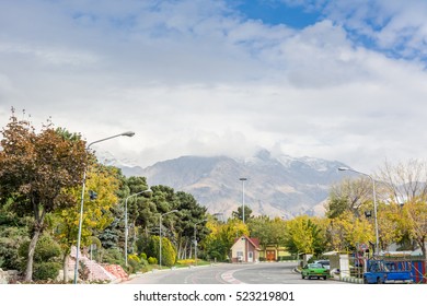 Winter Tehran Street View A Snow Covered Alborz Mountains Against Cloudy Sky On Background