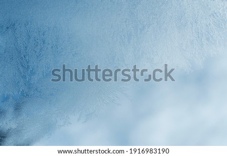 Winter texture background, frost pattern on window. Frosted icy glass