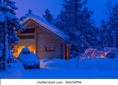 Winter Thick Forest. Evening. A Lot Of Snow. A Small House With Lighted Windows And The Car In Front Of The House