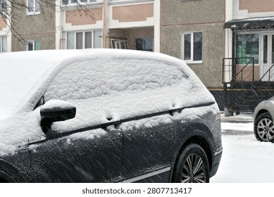 Winter. A thick layer of snow had fallen, covering a car parked in a parking lot.