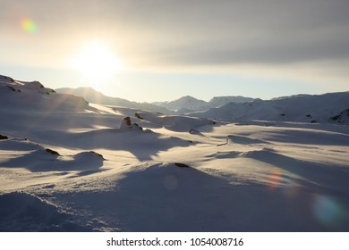Winter time, snow shore, Russia, landscape of beautiful wild nature of north sees. Beautiful snow winter ice and cold landscape, picturesque view with mountains on horizon, sky clouds, sun lens flare
