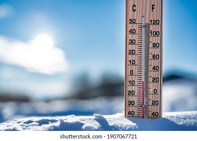 Winter time. Thermometer on snow shows low temperatures in celsius. - Powered by Shutterstock