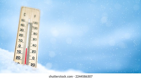 Winter time. Thermometer on snow with blur backround shows low temperatures. celsius and farenheit. - Powered by Shutterstock