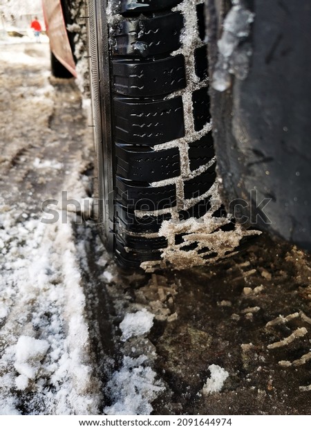 Winter\
tire. close up photo of car tire with snow in\
it