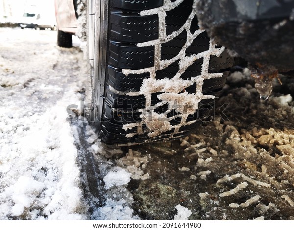 Winter\
tire. close up photo of car tire with snow in\
it