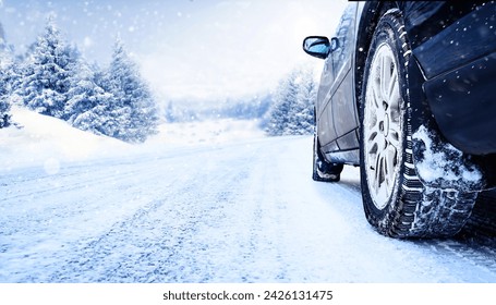 Winter tire closeup. Car on snowy road with beautiful landscape. - Powered by Shutterstock