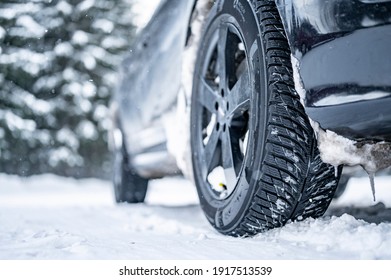 Winter tire. Detail of car tires in winter on the road covered with snow.