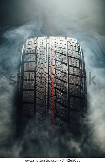 winter tire in smoke, closeup\
view