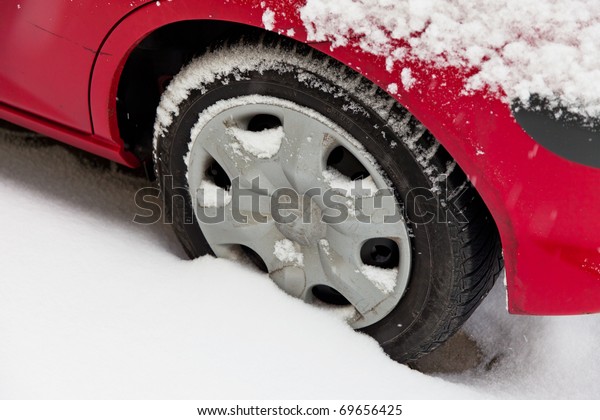 Winter\
tires of a car in the snow. Driving in the\
winter.