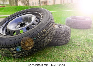 Winter Tires Close Up With Flare Effect. Self Replacement Of Winter Tires On A Car With Summer Wheels. Swap Winter Wheel For Summer Tire.