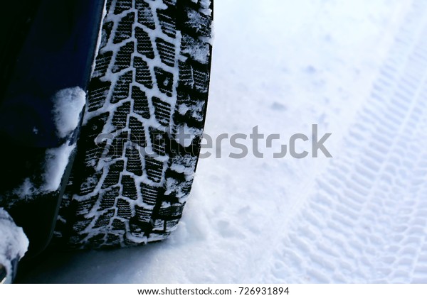 winter tires on wheels car in winter. snowfall\
outside the city