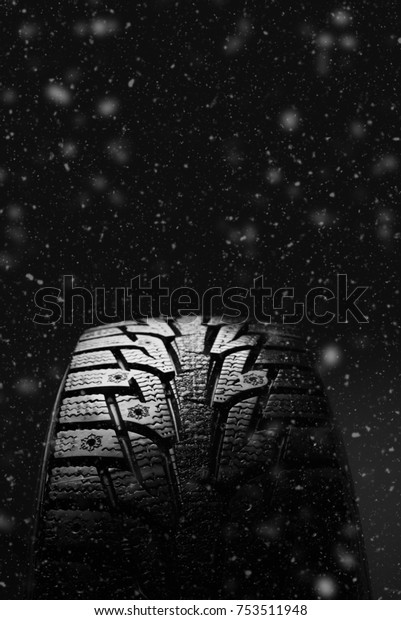 Winter tires. Tires for winter with snow on a\
black background