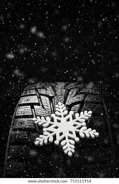 Winter tires. Tires for winter with snow on a\
black background
