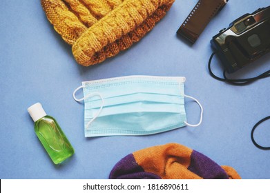 Winter Tourism During Coronavirus COVID-19 Restriction. Travel Accessories And Disposable Face Mask, Hydroalcoholic Sanitizer Gel