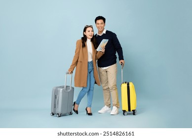 Winter travel portrait collection of Asian couple with baggage in studio blue color isolated background - Powered by Shutterstock