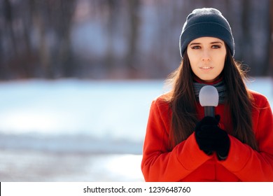 Winter TV Reporter Broadcasting Outdoors In The Snow. Professional Journalist Working On Field In Wintertime
