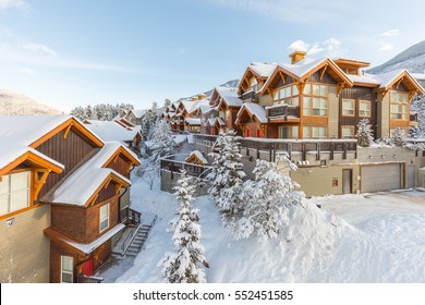 Winter Vacation Town Homes Or Condos In The Mountain Ski Resort Covered With Snow, Hot Tub And Blue Sky.