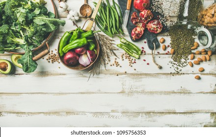 Winter Vegetarian, Vegan Food Cooking Ingredients. Flat-lay Of Vegetables, Fruit, Beans, Cereals, Kitchen Utencil, Dried Flowers, Olive Oil Over White Wooden Background, Top View, Copy Space