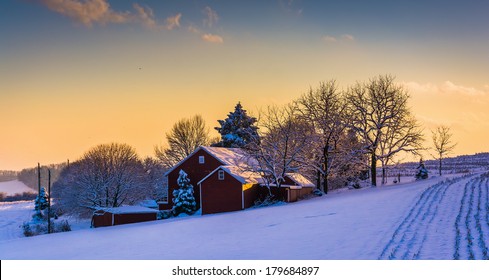 Winter View Of A Barn On A Snow Covered Farm Field At Sunset, In Rural York County, Pennsylvania.